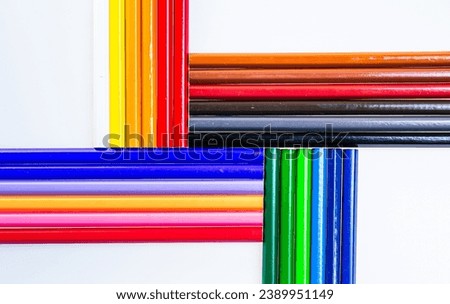 A Vibrant Array of Colored Pencils on a Clean White Surface. A group of different colored pencils on a white surface