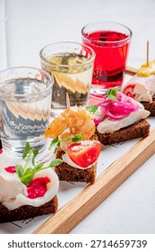 A vibrant array of small bites showcasing shrimp and vegetables alongside glasses of drinks.