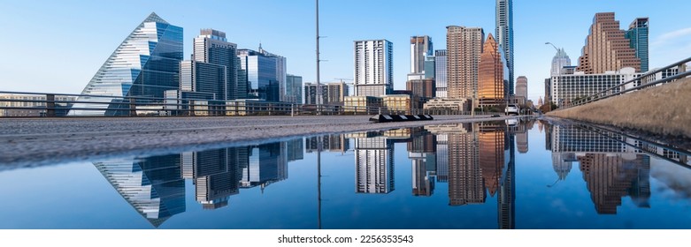 Vibrant Austin Texas city panoramic skyline, and modern buildings reflections on the rainwater over the Congress Avenue Bridge Road over the Lady Bird Lake in Colorado River