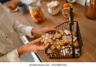 A vibrant basket of festive gingerbread cookies, decorated with snowflakes and charming houses, makes the ideal centerpiece for holiday celebrations and family gatherings this winter - Powered by Shutterstock