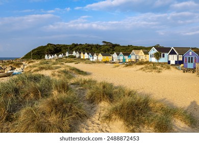 Vibrant Beach huts on Mudeford Spit in Dorset, England. Beach huts here are the most expensive in UK. - Powered by Shutterstock