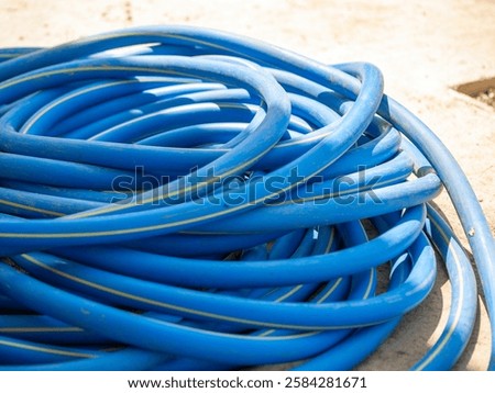 Similar – Image, Stock Photo Garden hose lies on a square terrace of stone tiles in a well-kept garden with lawn and a planting strip
