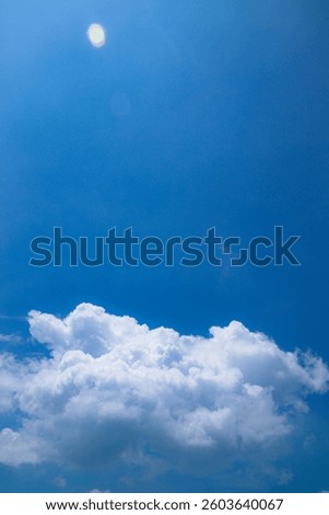 Vibrant blue sky with fluffly cloud