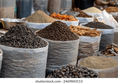 Vibrant bowls overflow with an array of aromatic spices at a bustling market. From fiery red chili flakes to earthy turmeric, these culinary essentials beckon adventurous cooks. - Powered by Shutterstock