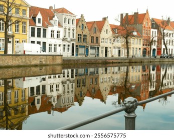 Vibrant buildings line the edge of a calm canal, showcasing intricate architecture and rich colors. The reflections create a serene atmosphere in this picturesque European setting. - Powered by Shutterstock