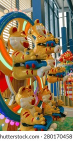 A vibrant carousel ride features multiple cheerful tiger-shaped seats, illuminated with colorful lights, ready for children's enjoyment