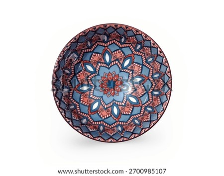 Vibrant ceramic serving bowl features an intricate, striking red, blue, and white geometric mandala pattern design.