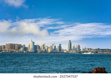 Vibrant City Skyline Against a Clear Blue Sky Over Calm Waters   - Powered by Shutterstock