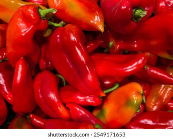 A vibrant close-up of fresh red bell peppers, showcasing their glossy surface, rich color, and natural texture. Perfectly stacked, they highlight freshness and culinary appeal. - Powered by Shutterstock