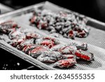 Vibrant close-up of freshly prepared European Lobsters (Homarus gammarus) piled in a metal tray, showcasing their rich red and brown shells. Ideal for culinary, seafood, and gourmet themes.