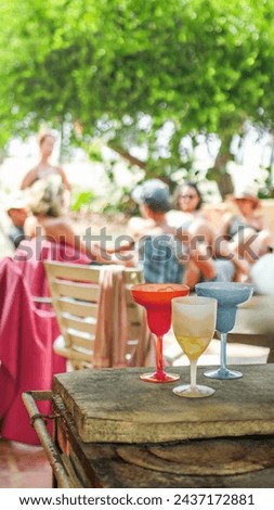 Similar – Woman holding lemonade glass and friends cooking in barbecue