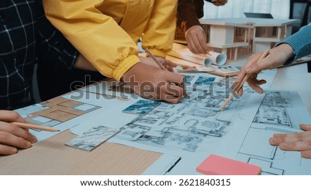 A vibrant collaborative design session showcasing diverse hands engaged in creating architectural blueprints and models, highlighting teamwork and creativity in a bright workspace. SACTR