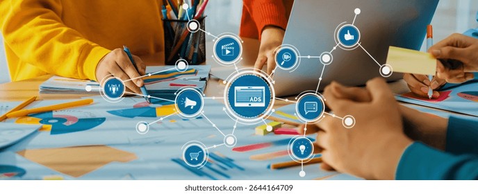 A vibrant and collaborative workspace showcasing hands engaging in project development with colorful materials, digital tools, and an ads strategy overlay. Amity
