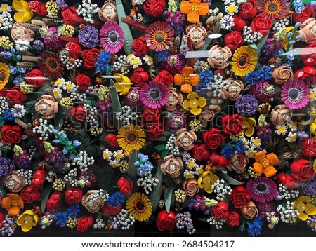 A vibrant collection of multicolored plastic bricks and creative flower builds. Showcases creativity, play, and learning for children's topics, DIY, and toy concepts.