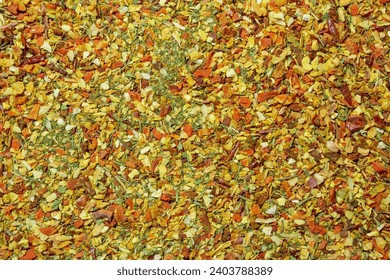 Vibrant and Colored Vegetable Seasoning Mix: A Culinary Canvas of Aromatic Seasoning - Textured Background for Gourmet Cooking. The Harmonious Combination of Fresh Herbs and Spices - Top View - Powered by Shutterstock