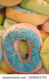 A Vibrant and Colorful Array of Candy Donuts with Sprinkles Piled High