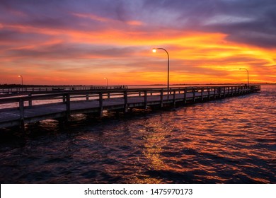 Vibrant Colors Light Up The Sky Just After Sunset Over A Long Fishing Pier. Jones Beach State Park, Long Island New York