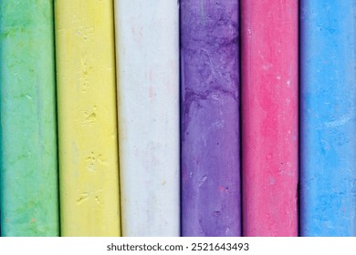 A vibrant display of colorful chalk sticks arranged in a row. Ideal for themes related to art, education, creativity, and crafting. - Powered by Shutterstock