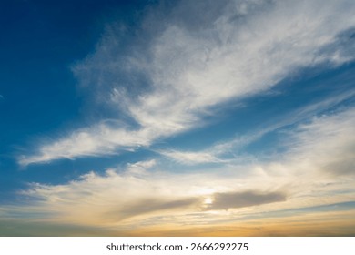 A vibrant and dramatic sky with wispy clouds, showcasing the transition from bright blue to a warm, golden hue as the sun sets. The photo was taken during a Nile cruise near Luxor and Esna.