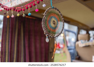 A vibrant dreamcatcher hanging inside a colorful van, adorned with decorative beads and textiles. The dreamcatcher features intricate details and captivating colors, symbolizing protection. - Powered by Shutterstock