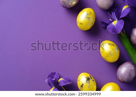 Vibrant Easter composition with yellow and purple eggs and purple irises on a purple background. Flat lay, top view, copy space