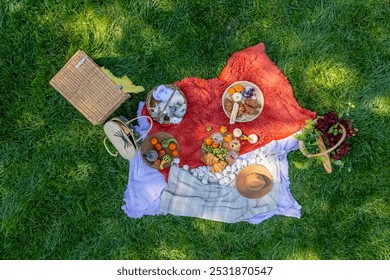 A vibrant fall picnic spread features colorful seasonal foods—bright pumpkins, apples, charcuterie, fresh bread, cheese, and warm drinks. Surrounded by golden leaves and cozy blankets. - Powered by Shutterstock