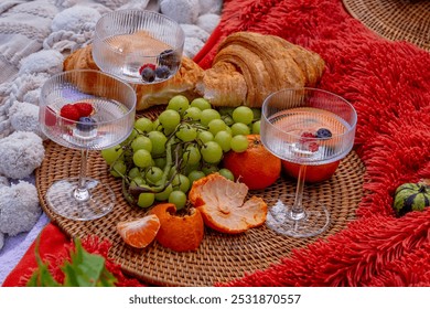 A vibrant fall picnic spread features colorful seasonal foods—bright pumpkins, apples, charcuterie, fresh bread, cheese, and warm drinks. Surrounded by golden leaves and cozy blankets. - Powered by Shutterstock