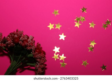 A vibrant festive composition featuring red decorative berries and shiny golden stars on a rich pink background. Elegant decor creates an atmosphere of joy and is perfect for birthday or New Year greeting card designs.