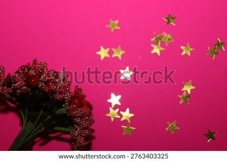 A vibrant festive composition featuring red decorative berries and shiny golden stars on a rich pink background. Elegant decor creates an atmosphere of joy and is perfect for birthday or New Year greeting card designs.