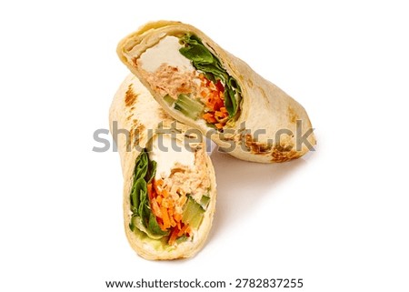 Vibrant fish and vegetable filled wrap. Attractive presentation of fresh vegetables and smooth fish in wrap