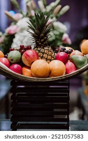 Vibrant fruit arrangement with pineapple, apples, oranges, and grapes