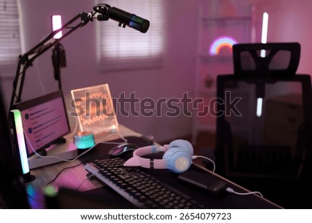 Vibrant gaming streaming workspace empty desk ready for live content creation professional equipment setup technology room interior cozy atmosphere neon lights