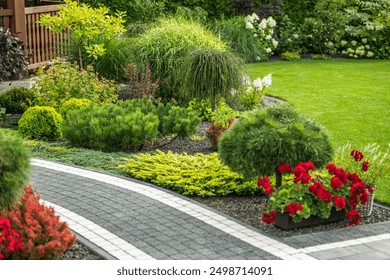 A vibrant garden features neatly arranged flower beds, diverse greenery, and a curved stone pathway under the afternoon sun. - Powered by Shutterstock