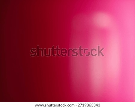 A vibrant gradient of luminous pink and deep red hues creating an abstract background with soft light effects