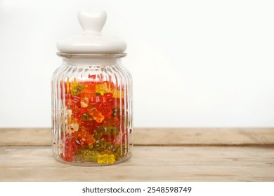 Vibrant gummy candies, gummy bears in transparent jar, offering burst of color and sweetness against rustic wooden background - Powered by Shutterstock