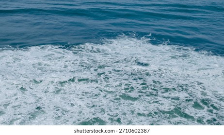 A vibrant image capturing the dynamic energy of ocean waves, showcasing the interplay of deep blue water and frothy white foam in a natural seascape.