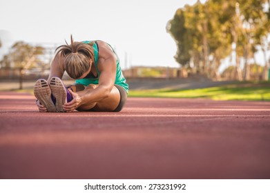 vibrant image of a female athlete stretching on a running track - Powered by Shutterstock