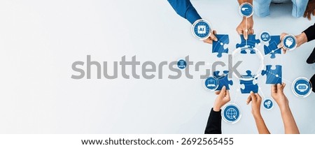 A vibrant image showcasing diverse hands collaborating to assemble blue puzzle pieces representing technology and innovation concepts on a clean, bright surface. Amity