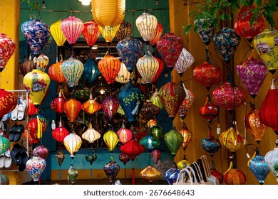 Vibrant, intricately patterned lanterns in assorted shapes and colors hang gracefully along a timeworn Vietnam market, showcasing exquisite traditional artistry.