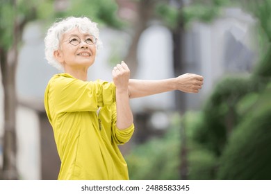 Vibrant Japanese senior women doing preparatory exercises and stretching. Images of health, exercise and sport. - Powered by Shutterstock