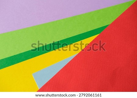 Vibrant layered paper pattern forms bright geometric composition ideal for design, print and art projects