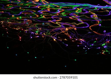 Vibrant light trails create an abstract pattern at night.