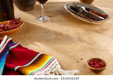 Vibrant Mexican Textile and Chili Peppers on Wooden Table with Warm Lighting. - Powered by Shutterstock