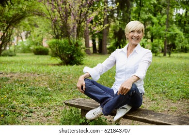 Vibrant Mid Age Woman Laughing In Park 