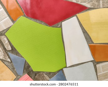 Vibrant Mosaic background Displaying Assemblage of Colored Tiles. Array of brightly colored and textured tiles arranged in captivating mosaic pattern. Close-up. Copy space. Selective focus.