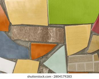 Vibrant Mosaic background Displaying Assemblage of Colored Tiles. Array of brightly colored and textured tiles arranged in captivating mosaic pattern. Close-up. Copy space. Selective focus.