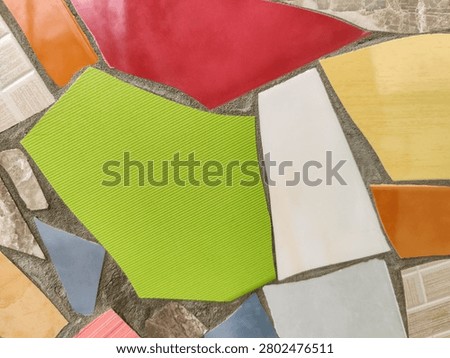 Vibrant Mosaic background Displaying Assemblage of Colored Tiles. Array of brightly colored and textured tiles arranged in captivating mosaic pattern. Close-up. Copy space. Selective focus.