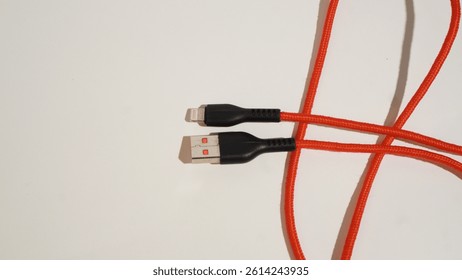 Vibrant orange braided cable with multiple connector types on clean backdrop