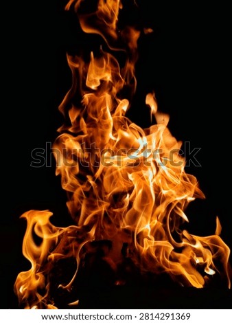 Vibrant Orange Fire Flames Shaped Like Human Figure on Black Background