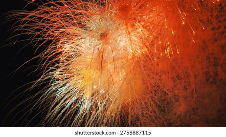 Vibrant orange and yellow fireworks exploding at night during Moscow celebration